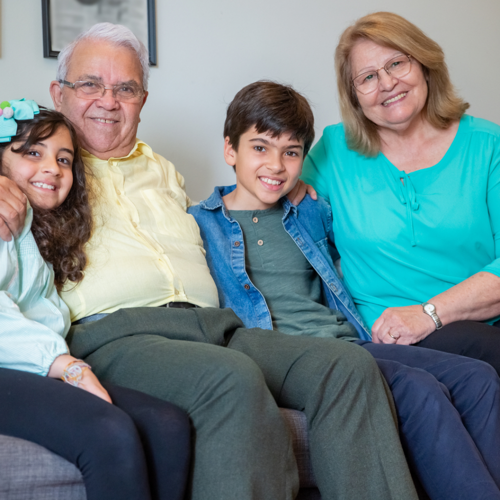 Two grandparents sitting with their two grandchildren.
