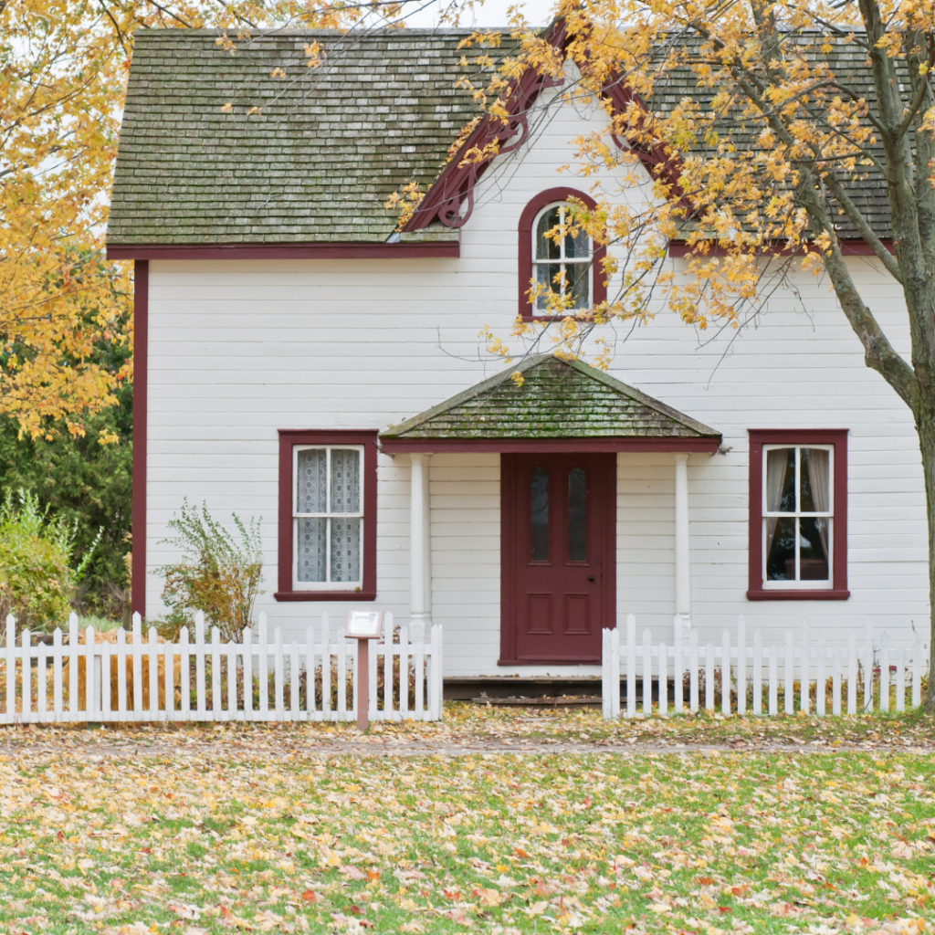A white house with a white picket fence.